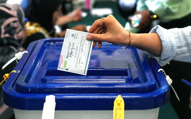An Iranian woman casts her ballot during voting at a polling station in Tehran for the Islamic Republic's presidential election on June 28, 2024. (Raheb Homavandi/AFP) An Iranian woman casts her ballot during voting at a polling station in Tehran for the Islamic Republic's presidential election on June 28, 2024. (Raheb Homavandi/AFP)