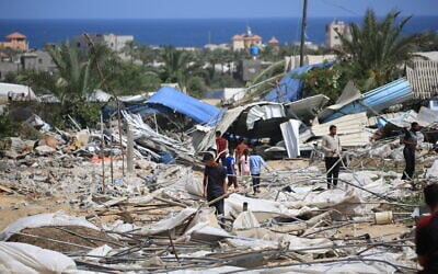 People look for salvageable items following an Israeli raid in Rafah in the southern Gaza Strip, June 29, 2024. (Eyad Baba/AFP)