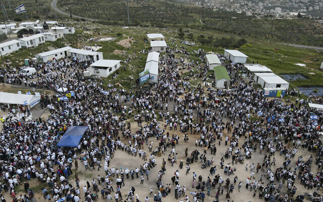 Israeli settlers and supporters gather in the outpost of Evyatar in the West Bank, April 10, 2023. (AP/Ariel Schalit) Israeli settlers and supporters gather in the outpost of Evyatar in the West Bank, April 10, 2023. (AP/Ariel Schalit)