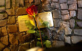 Illustrative: A rose is placed near freshly polished so-called stumbling stones commemorating people, most of them Jews, deported and killed by the Nazis, in Berlin, Germany, November 8, 2023. (AP Photo/Markus Schreiber)
