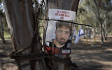 A poster depicting Israeli hostage Guy Gilboa-Dalal is displayed in Re'im, Feb. 26, 2024 at the Nova music festival memorial site where he was kidnapped to Gaza by Hamas on Oct. 7, 2023. (AP/Maya Alleruzzo)
