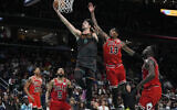 Washington Wizards forward Deni Avdija (8) drives to the basket past Chicago Bulls forward Torrey Craig (13) during the second half of an NBA basketball game in Washington, April 12, 2024. (Mark Schiefelbein/AP)