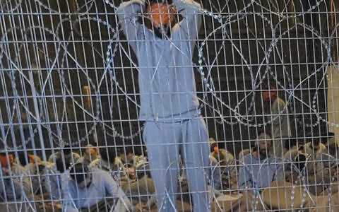 Blindfolded Palestinians captured in the Gaza Strip in a detention facility on the Sde Teiman military base in southern Israel, winter 2023. (Breaking The Silence via AP)