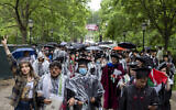 University of Chicago students, including Youssef Hasweh, second from left, one of four students the university is withholding degrees from due to their involvement in an anti-Israel encampment, walk out of the university's convocation ceremony, June 1, 2024. (Vincent Alban/Chicago Tribune via AP)