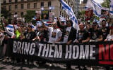 Family members of Israeli hostages march during the annual Israel Day Parade on Fifth Avenue on June 2, 2024, in New York. (AP Photo/Yuki Iwamura)