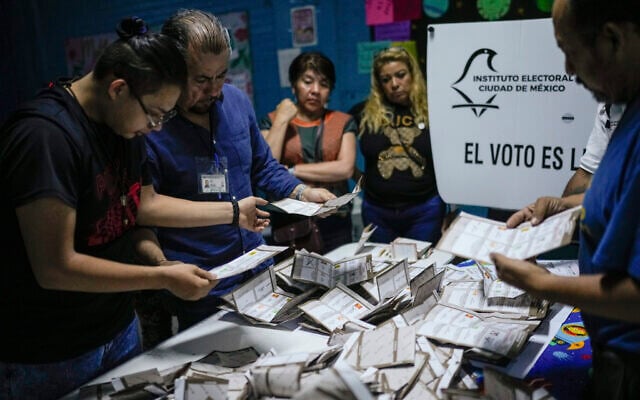 Electoral officials and poll watchers count votes after polls closed during general elections in Mexico City, Sunday, June 2, 2024. (AP/Matias Delacroix) Electoral officials and poll watchers count votes after polls closed during general elections in Mexico City, Sunday, June 2, 2024. (AP/Matias Delacroix)