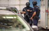 Members of a special unit of the Romanian gendarmerie stand outside the apartment block in which the Israeli embassy is located in Bucharest, Romania, Monday, June 3, 2024, after a suspect threw a Molotov cocktail at the embassy. (AP Photo/Vadim Ghirda)
