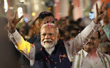 Prime Minister Narendra Modi greets supporters as he arrives at Bharatiya Janata Party (BJP) headquarters in New Delhi, India, Tuesday, June 4, 2024. (AP Photo/Manish Swarup)
