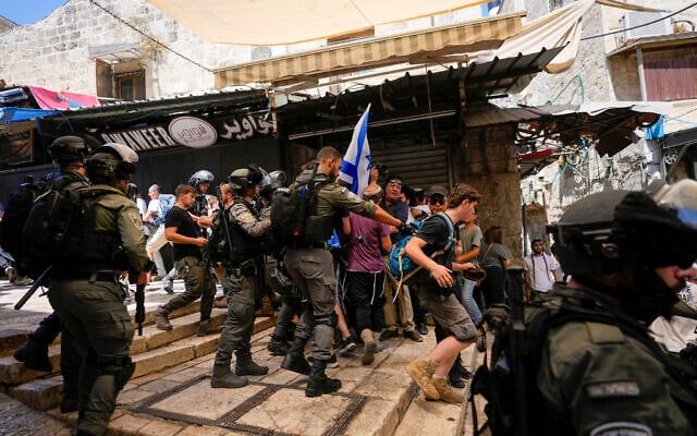 Israeli police officers separate Israelis and Palestinians in a street in the Muslim Quarter of Jerusalem's Old City, shortly before a march through the area by Jewish nationalists in Jerusalem Day. (AP Photo/Ohad Zwigenberg) Israeli police officers separate Israelis and Palestinians in a street in the Muslim Quarter of Jerusalem's Old City, shortly before a march through the area by Jewish nationalists in Jerusalem Day. (AP Photo/Ohad Zwigenberg)