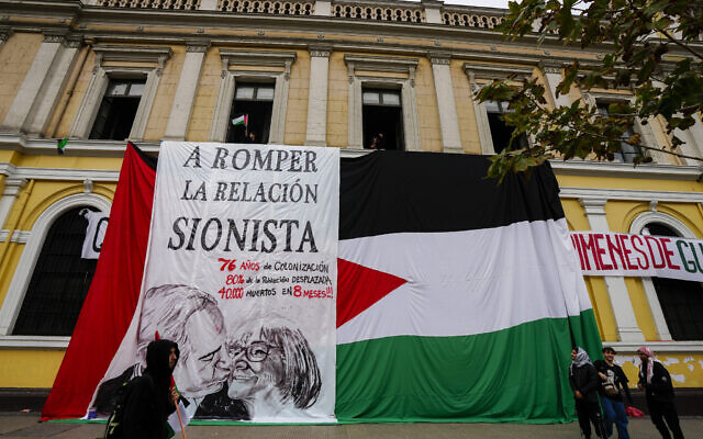 A banner depicting Israel's Prime Minister Benjamin Netanyahu kissing the University of Chile rector, Rosa Deves, is displayed by students who are demanding the university break relations with Israeli universities, during an anti-Israel protest in Santiago, Chile, Saturday, June 8, 2024. (AP Photo/Esteban Felix)