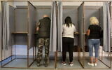 Voters fill in their ballot papers at a polling station during the European Parliament and the local elections in Salgotarjan, Hungary, June 9, 2024. (Peter Komka/MTI via AP)