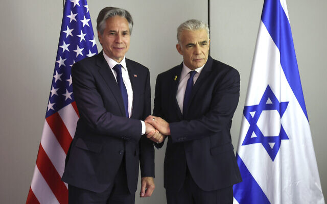 US Secretary of State Antony Blinken, left, shakes hands with Opposition Leader Yair Lapid during a meeting in Tel Aviv, June 11, 2024. (Jack Guez/Pool Photo via AP)