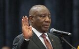 South African President Cyril Ramaphosa raises his hand as he is sworn is as a member of Parliament ahead of an expected vote by lawmakers to decide if he is reelected as leader of the country in Cape Town, South Africa, Friday, June 14, 2024. (AP Photo/Jerome Delay)