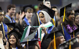 A UCLA graduating student holds a Palestinian flag during the commencement ceremony inside Pauley Pavilion on the UCLA campus, in Los Angeles, June 14, 2024. (AP/Damian Dovarganes)