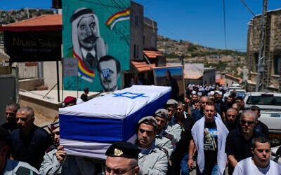 Soldiers carry the flag-draped casket of Capt. Wassem Mahmoud during his funeral in the village of Beit Jann, northern Israel, June 16, 2024 (AP Photo/Ohad Zwigenberg)
