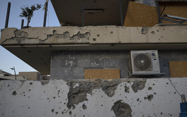 A damaged building, from previous shelling attacks from Lebanon, is seen in the northern city of Kiryat Shmona on June 19, 2024. (AP Photo/Leo Correa)