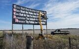 Illustrative: Workers repaint a Ten Commandments billboard off of Interstate 71 on Election Day near Chenoweth, Ohio, November 7, 2023. Louisiana has become the first state to require that the Ten Commandments be displayed in every public school classroom under a bill signed into law by Republican Gov. Jeff Landry on June 19. (AP Photo/Carolyn Kaster, File)