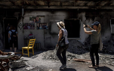 A group of Israelis on an educational tour visit the home of the Siman Tov family in Kibbutz Nir Oz on Friday, June 21, 2024. The parents and three children were killed and their home was torched by Hamas terrorists on October 7, 2023. (AP Photo/Ohad Zwigenberg) A group of Israelis on an educational tour visit the home of the Siman Tov family in Kibbutz Nir Oz on Friday, June 21, 2024. The parents and three children were killed and their home was torched by Hamas terrorists on October 7, 2023. (AP Photo/Ohad Zwigenberg)