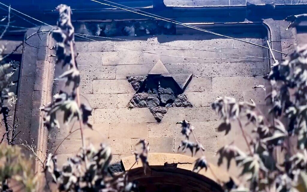 In this photo taken from video released by The Telegram Channel of the head of Dagestan Republic of Russia on June 24, 2024, a damaged Star of David is seen on the wall of the the Kele-Numaz synagogue in Derbent after an attack by gunmen a day earlier. (Telegram Channel of the head of Dagestan Republic of Russia via AP)