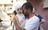 A Palestinian man reacts as he says goodbye to his sick daughter before leaving the Gaza Strip to get treatment abroad through the Kerem Shalom crossing, in Khan Younis, southern Gaza Strip, Thursday, June 27, 2024. (AP Photo/Abdel Kareem Hana)