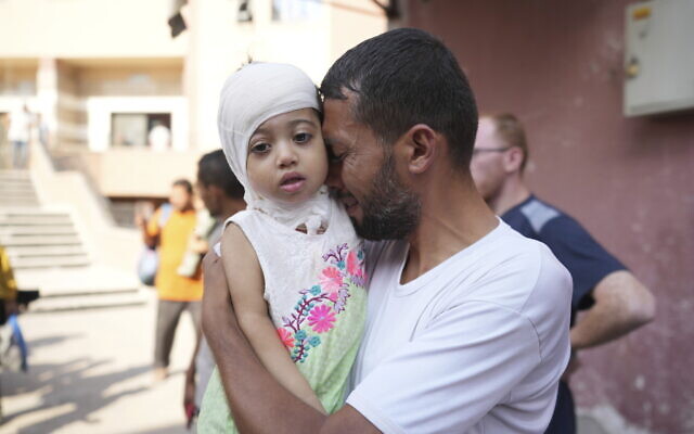 A Palestinian man reacts as he says goodbye to his sick daughter before leaving the Gaza Strip to get treatment abroad through the Kerem Shalom crossing, in Khan Younis, southern Gaza Strip, Thursday, June 27, 2024. (AP Photo/Abdel Kareem Hana) A Palestinian man reacts as he says goodbye to his sick daughter before leaving the Gaza Strip to get treatment abroad through the Kerem Shalom crossing, in Khan Younis, southern Gaza Strip, Thursday, June 27, 2024. (AP Photo/Abdel Kareem Hana)