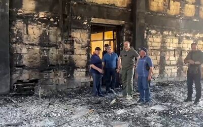 In this photo taken from video released by the head of Dagestan Republic of Russia on June 24, 2024, Dagestan Gov. Sergei Melikov, center, visits the damaged Kele-Numaz synagogue in Derbent, Russia. (The Telegram Channel of the head of Dagestan Republic of Russia via AP)