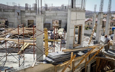 Illustrative: Palestinian construction workers at a building site in the Israeli settlement of Efrat in the West Bank, on September 29, 2020. (Gershon Elinson/Flash90)