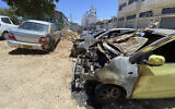Torched cars and vandalized stores in Jaffa Tel Aviv, following a night of rioting by Arab residents in the city, on May 15, 2021. (Avshalom Sassoni/Flash90