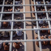 Gazan detainees seen in a courtyard in a prison in southern Israel, February 14, 2024. (Chaim Goldberg/Flash90)