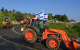 Farmers from the Golan Heights demonstrate with colleagues from all over Israel against the war and the security of the borders in a convoy of agricultural trucks, Kibbutz Mevo Hama, southern Golan Heights , February 22, 2024. (Michael Giladi/Flash90)