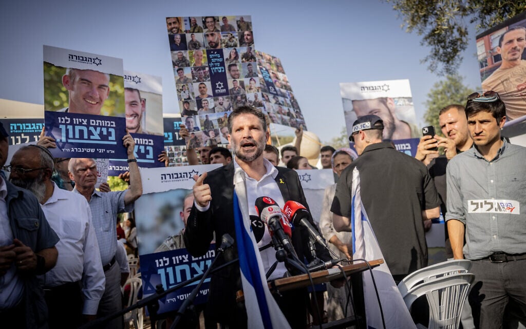 Finance Minister Bezalel Smotrich, head of the Religious Zionism party, speaking next to a protest tent organized by bereaved families of soldiers killed during the war in Gaza, close to the Supreme Court in Jerusalem, June 3, 2024. (Chaim Goldberg/Flash90) Finance Minister Bezalel Smotrich, head of the Religious Zionism party, speaking next to a protest tent organized by bereaved families of soldiers killed during the war in Gaza, close to the Supreme Court in Jerusalem, June 3, 2024. (Chaim Goldberg/Flash90)