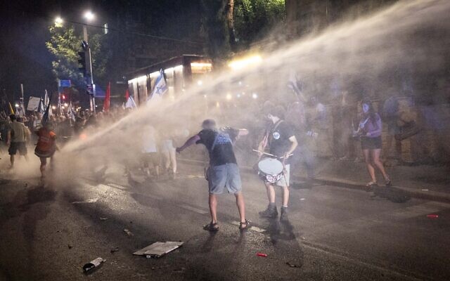 Police deploy a water cannon against anti-government protesters outside the prime minister's residence in Jerusalem, on June 17, 2024. (Yonatan Sindel/Flash90)