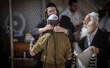 An Israeli soldier and ultra-Orthodox Jews at the Western Wall on June 25, 2024. (Chaim Goldberg/Flash90)