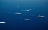 INS Komemiyut landing craft is seen being escorted into Israel's territorial waters by other Navy vessels, June 16, 2024. (Israel Defense Forces)
