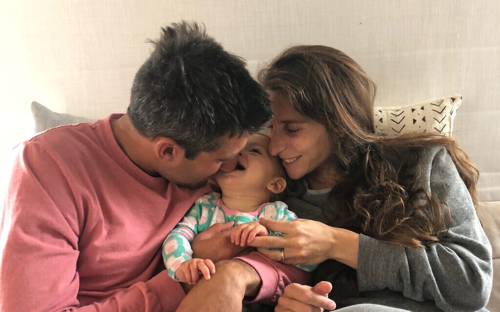 Myra Sack and Matt Goldstein holding Havi Lev Goldstein. (Courtesy)
