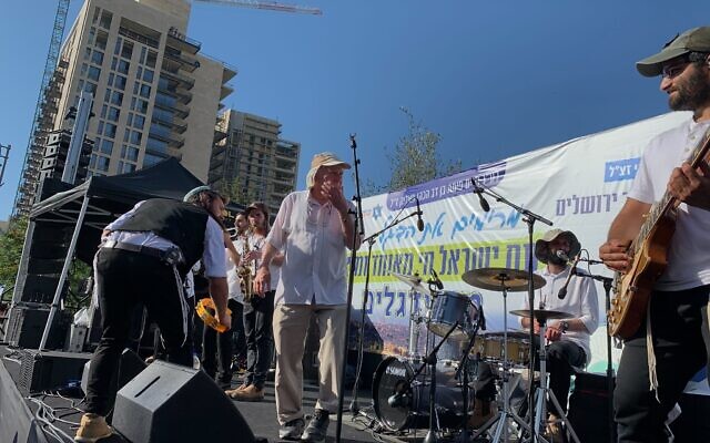 Flag March co-founder Meir Indor goes up onstage to address crowd at a Jerusalem Day rally before the flag march sets out to the Old City on June 5, 2024. (Charlie Summers / The Times of Israel Flag March co-founder Meir Indor goes up onstage to address crowd at a Jerusalem Day rally before the flag march sets out to the Old City on June 5, 2024. (Charlie Summers / The Times of Israel