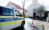 A police vehicle stands in front of the synagogue in the city center of Oldenburg, Germany, after an incendiary device was thrown at its door. (Hauke-Christian Dittrich/dpa via Getty Images via JTA