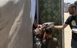 World Central Kitchen staff distribute food boxes to Palestinians in Gaza amid the ongoing conflict and severe humanitarian situation in the territory.(Courtesy World Central Kitchen/WCK.org)