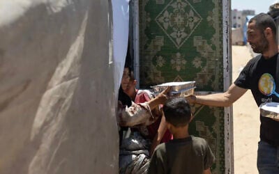 World Central Kitchen staff distribute food boxes to Palestinians in Gaza amid the ongoing conflict and severe humanitarian situation in the territory.(Courtesy World Central Kitchen/WCK.org)