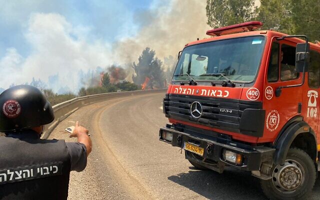 Firefighters work to extinguish a blaze in the Ramim Ridge area near Kiryat Shmona, June 3, 2024. (Fire and Rescue Services) Firefighters work to extinguish a blaze in the Ramim Ridge area near Kiryat Shmona, June 3, 2024. (Fire and Rescue Services)