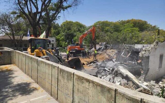 A demolition crew tears down a communal building in Kibbutz Be'eri on June 4, 2024. (Tekuma Authority)