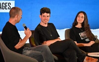 Israeli actor Eyal Kitzis (left) interviews cousin of Hamas hostage Gil Dickmann (center) as part of a panel at Hostages and Missing Families Forum conference in Sderot on June 17, 2024. (Paulina Patimer/Hostages and Missing Families Forum)