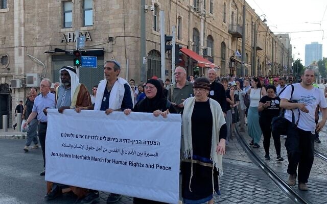 Participants in an interfaith march 'for human rights and peace' make their way to Jaffa Gate in Jerusalem on June 3, 2024. (Charlie Summers/Times of Israel) Participants in an interfaith march 'for human rights and peace' make their way to Jaffa Gate in Jerusalem on June 3, 2024. (Charlie Summers/Times of Israel)