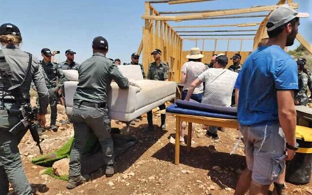 Border Police evacuate and dismantle a makeshift structure in an illegal West Bank outpost close to the Yair’s Farm settlement in the northern West Bank, June 4, 2024. (Courtesy Yair’s Farm)