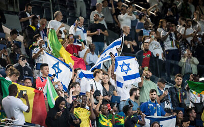Supporters of Israel and Mali fly their flags at the men's group D match at the Parc des Princes during the 2024 Summer Olympics, July 24, 2024, in Paris, France. (Olympic Committee of Israel)