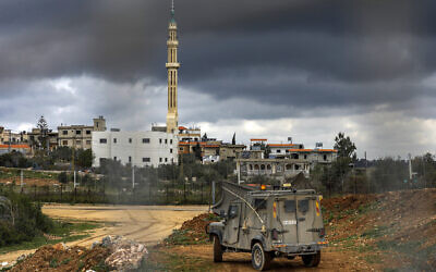 An Israeli armored military vehicle patrols along the border with Lebanon near the northern Arab Israeli village of Arab al-Aramshe on March 15, 2023. (JALAA MAREY / AFP)
