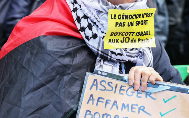File: A demonstrator wears a sticker reading "Genocide is not a sport, boycott Israel at the Paris Olympic Games" during a protest "against racism, against Islamophobia" at the call of various organization in Paris on April 21, 2024. (Alain JOCARD / AFP) File: A demonstrator wears a sticker reading "Genocide is not a sport, boycott Israel at the Paris Olympic Games" during a protest "against racism, against Islamophobia" at the call of various organization in Paris on April 21, 2024. (Alain JOCARD / AFP)