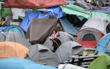 A protester stands amid tents in an anti-Israel encampment at McGill University in Montreal, Canada, April 29, 2024. (Graham Hughes / AFP)