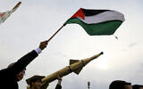 Yemenis wave Palestinian flags and hold mock rockets during a march in the Houthi-run capital Sanaa in solidarity with the people of Gaza on June 28, 2024. (MOHAMMED HUWAIS / AFP)