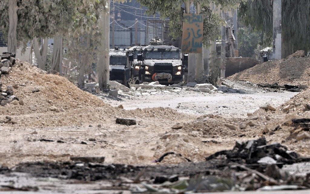 Illustrative: Armored IDF vehicles move through the Nur Shams camp, east of the northern West Bank city of Tulkarem, during a raid on July 1, 2024. (Zain Jaafar/AFP)